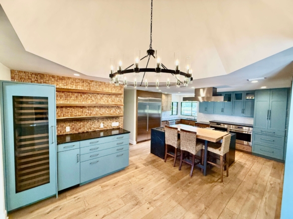 photo of kitchen with round chandelier and wine fridge in large kitchen