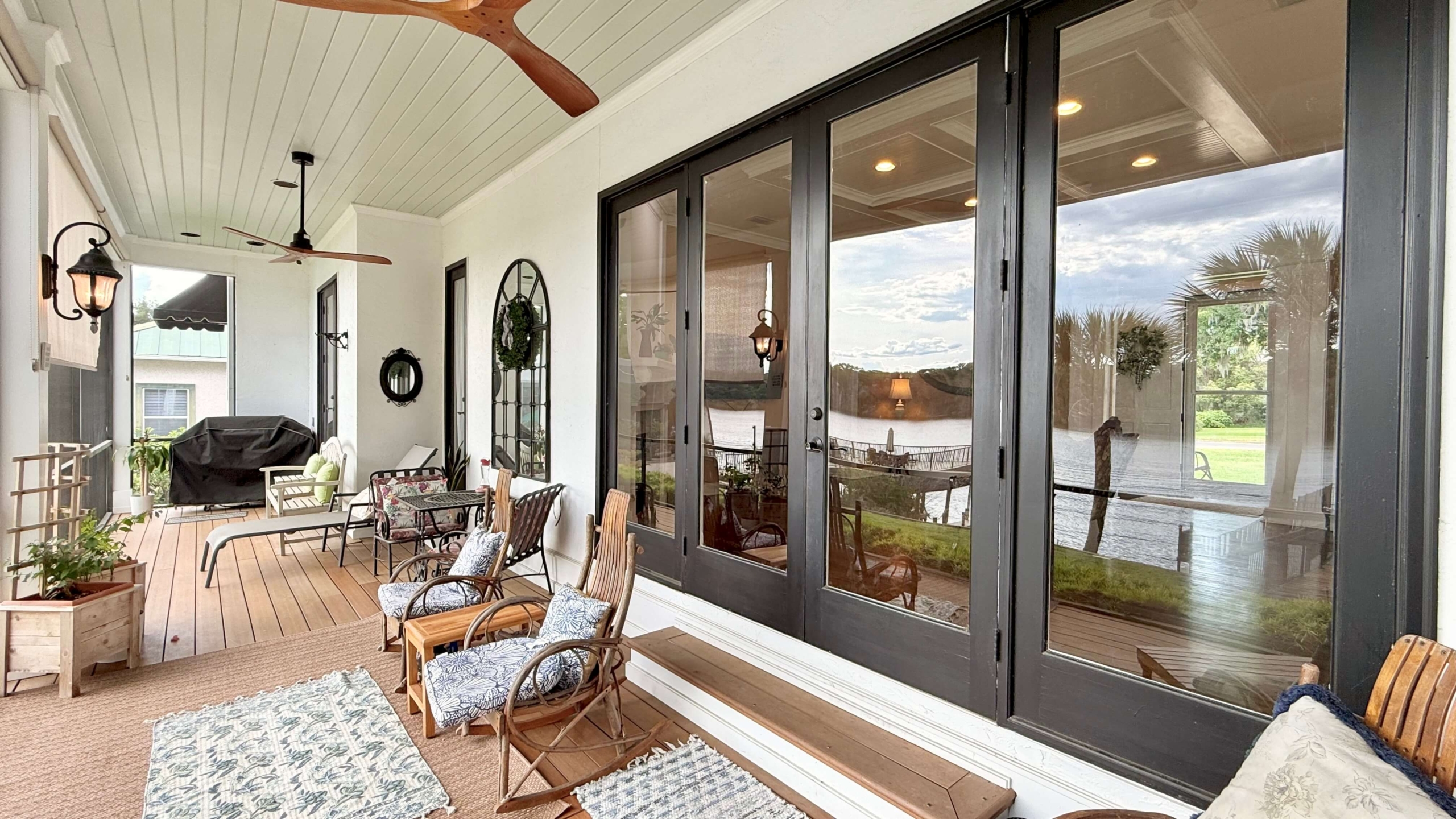 Photo of Back Porch Screen Lanai with Rocking Chairs on a Waterfront Home